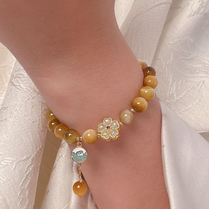 Bracelet courage en forme de clochette et œil de tigre doré naturel Buddha Stones - image 8