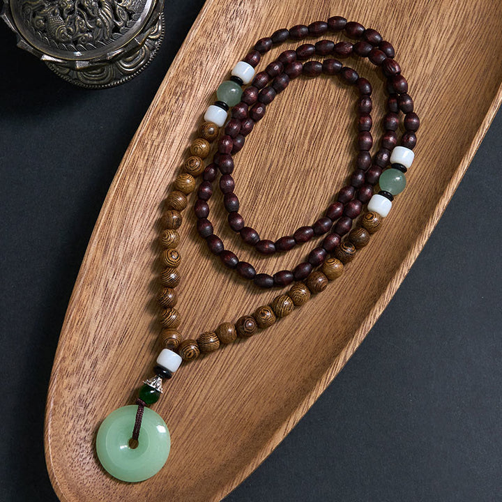 Collier avec pendentif en bois de wengé et Buddha Stones, boucle de paix, équilibre, tranquillité - Boucle en bois de wengé et boucle de la paix - image 0