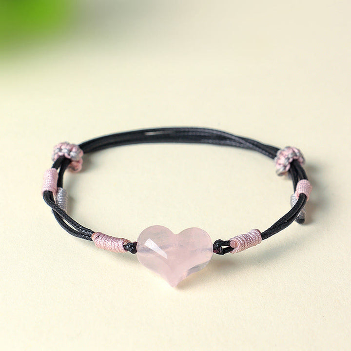 Bracelet chaleureux en Buddha Stones, breloque cœur en cristal rose naturel et cordon tressé. - image 1
