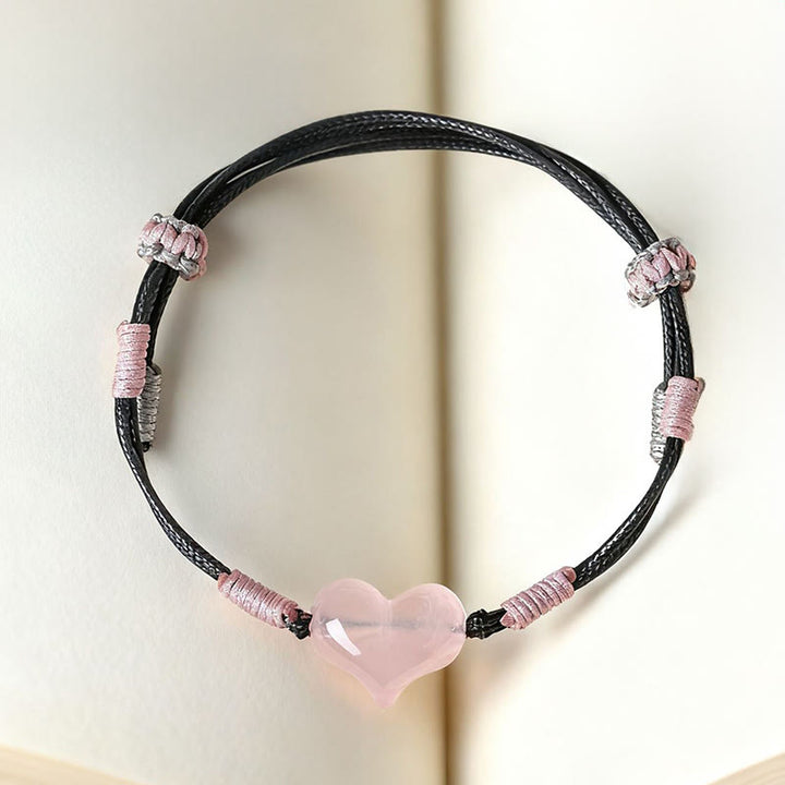 Bracelet chaleureux en Buddha Stones, breloque cœur en cristal rose naturel et cordon tressé. - image 3
