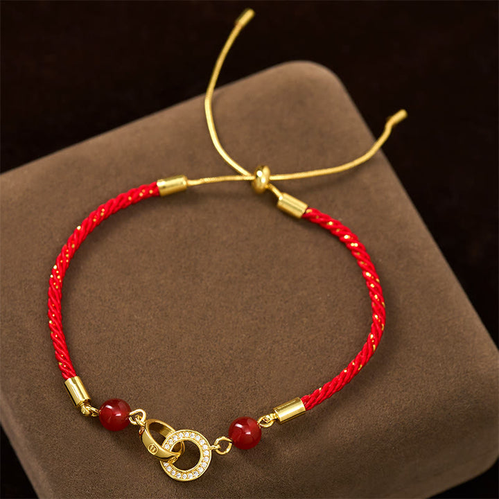 Bracelet de protection en cuivre plaqué or avec boucles de paix et Buddha Stones reliées par un cordon rouge - image 1