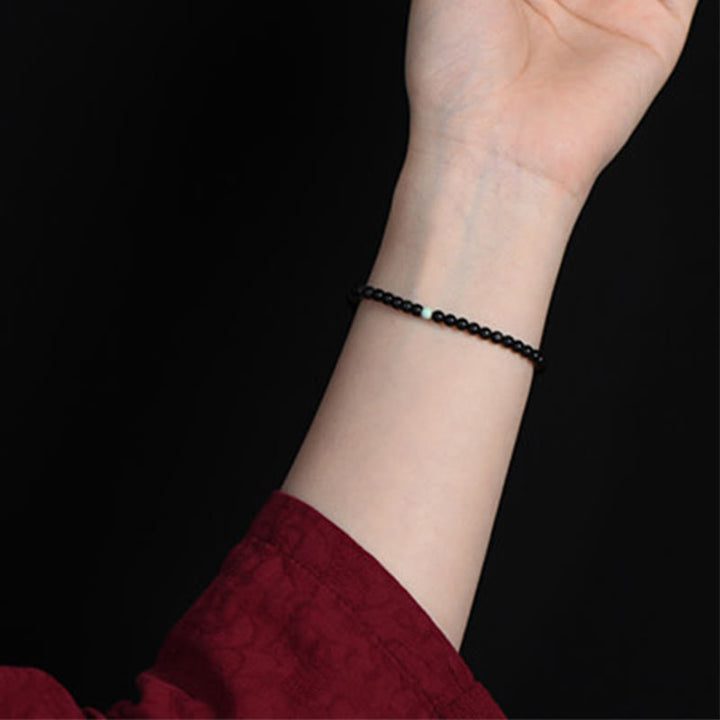 Bracelet de force et d'épanouissement en obsidienne noire et turquoise de Buddha Stones - image 7