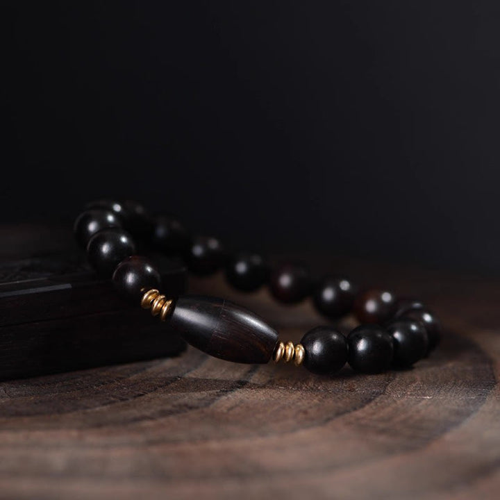 Bracelet de protection en perles d'ébène et Buddha Stones, orné d'un parchemin de sutra et symbole de bénédiction. - image 4