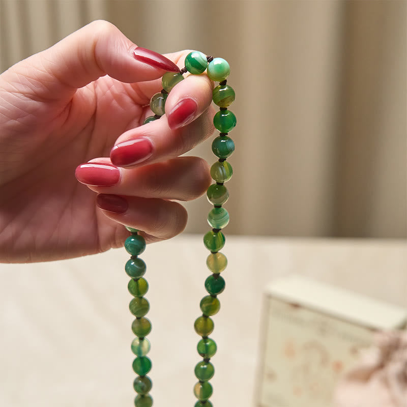 Bracelet de protection en Buddha Stones et pompon en malachite - image 4