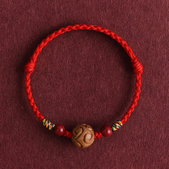 Bracelet porte-bonheur en corde de bois de pêcher naturel sculpté dans des Buddha Stones , orné d'un motif de bon augure - Cordon rouge (Tour de poignet : 13-18 cm) - image 1