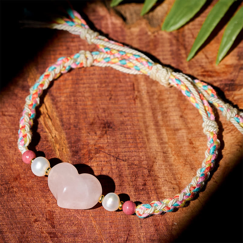 Bracelet en corde tressée rose avec cristal rose et motif cœur en Buddha Stones, symbole de chaleur et d'amour - image 1