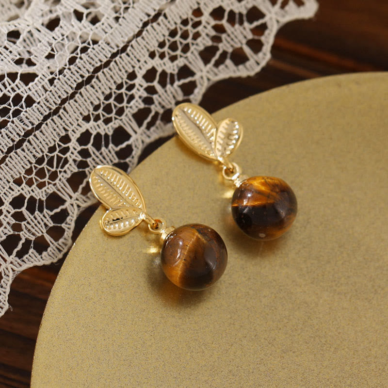 Buddha Stones Boucles d'oreilles de protection en cuivre avec motif de feuilles d'œil de tigre - image 1