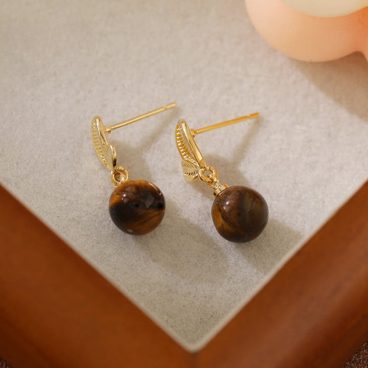 Buddha Stones Boucles d'oreilles de protection en cuivre avec motif de feuilles d'œil de tigre - image 2