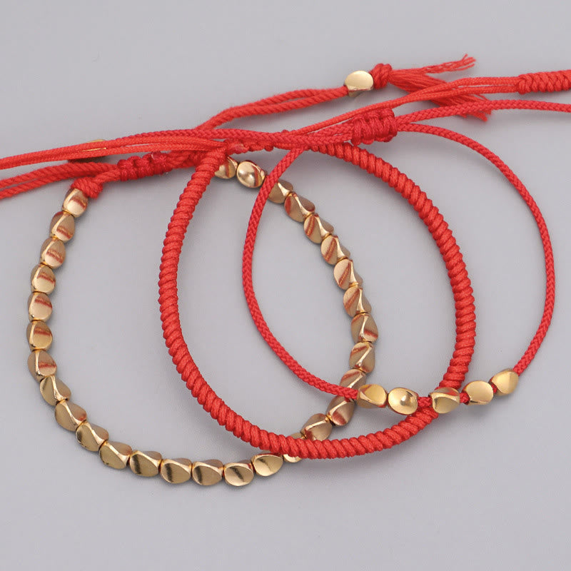 Buddha Stones Bracelet porte-bonheur composé de 3 perles en cuivre doré et d'un fil rouge - image 1