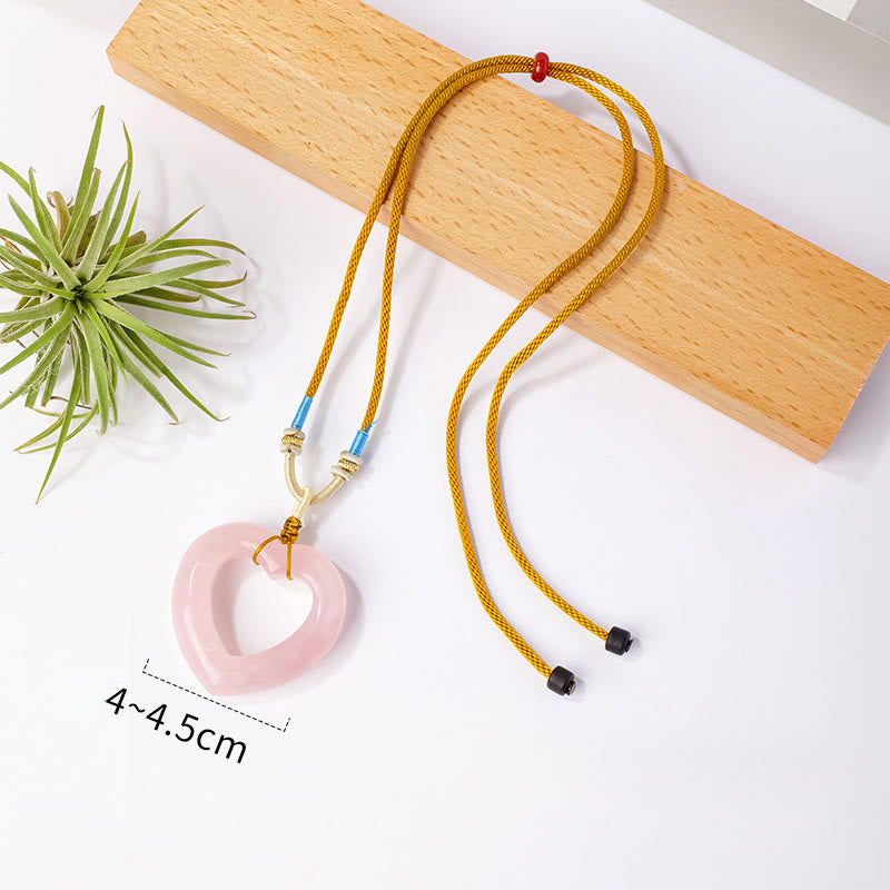 Buddha Stones Pendentif cœur creux en quartz rose naturel avec pendentif en quartz rose naturel représentant l'amour et la tendresse - Quartz rose naturel (la couleur, la forme et la taille peuvent varier) - image 1