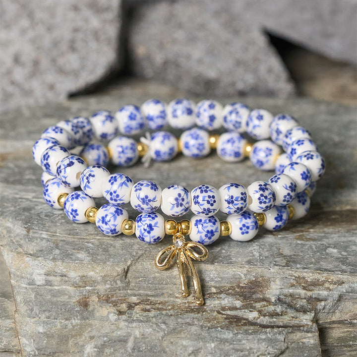 Buddha Stones Bracelet intérieur de la paix en porcelaine rose et blanche, orné d'un nœud papillon et de perles bleues et blanches - image 1