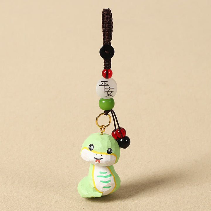 Buddha Stones Porte-clés en bois de tilleul gravé de fleurs de prunier, symbole de paix et de bien-être : Om Mani Padme Hum. - Serpent 4 cm (la couleur, la forme et la taille peuvent varier) - Paix et sécurité - image 25