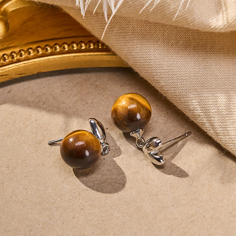 Buddha Stones Boucles d'oreilles en cuivre avec motif cœur œil de tigre et symbole du courage - image 1