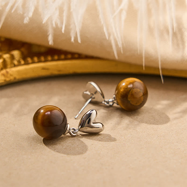 Buddha Stones Boucles d'oreilles en cuivre avec motif cœur œil de tigre et symbole du courage - image 2