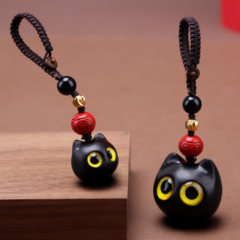 Buddha Stones Porte-clés en bois d'ébène sculptés à la main représentant un chat mignon symbolisant la paix et l'ancrage - image 0
