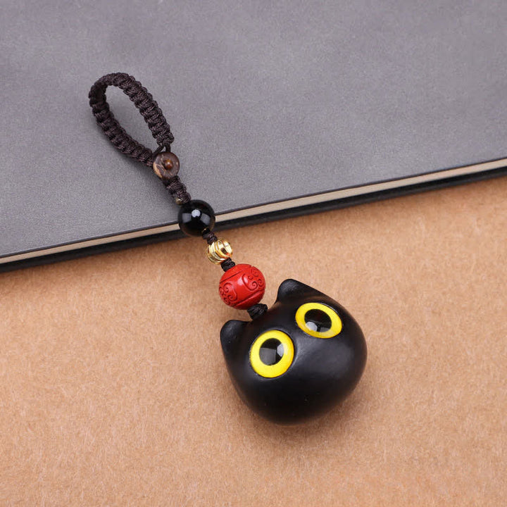 Buddha Stones Porte-clés en bois d'ébène sculptés à la main représentant un chat mignon symbolisant la paix et l'ancrage - Corde tressée pour gros chat - image 1