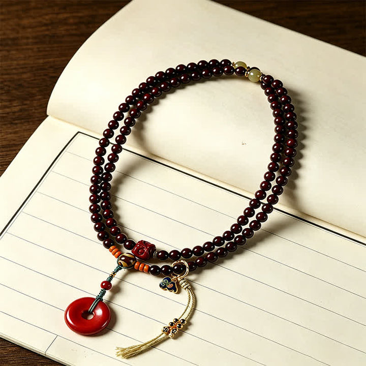 Buddha Stones Mala de protection tissée à la main en bois de santal rouge, avec boucle de paix et 108 perles - image 1