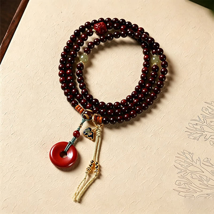 Buddha Stones Mala de protection tissée à la main en bois de santal rouge, avec boucle de paix et 108 perles - Bois de rose rouge (Énergie d'ancrage ♥ Force intérieure) - image 0