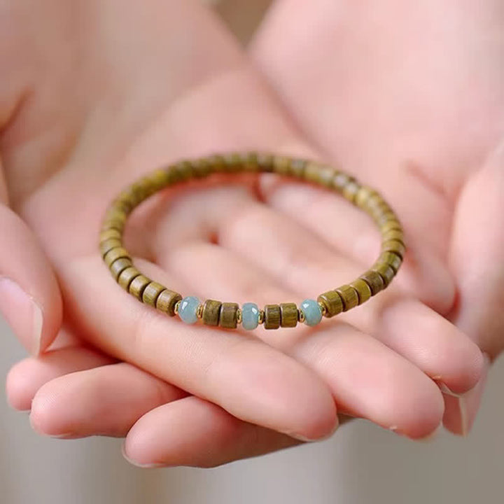 Buddha Stones Bracelet à perles cylindriques en bois de santal vert et jade, orné de santal et de pierres de sérénité - image 2