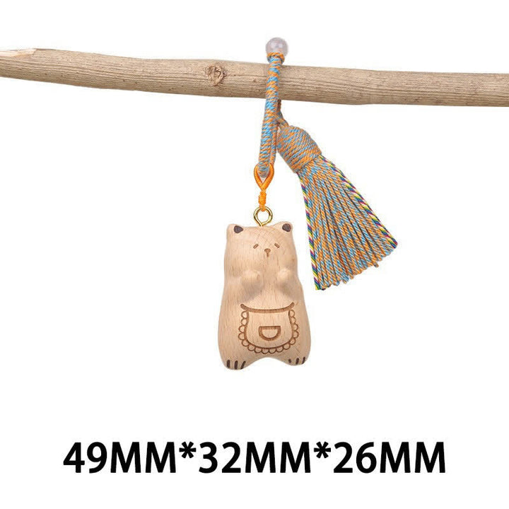 Buddha Stones Porte-clés porte-bonheur en bois clair sculpté à la main avec pompon chat, symbole d'ancrage - Ours à tablier bleu - image 29