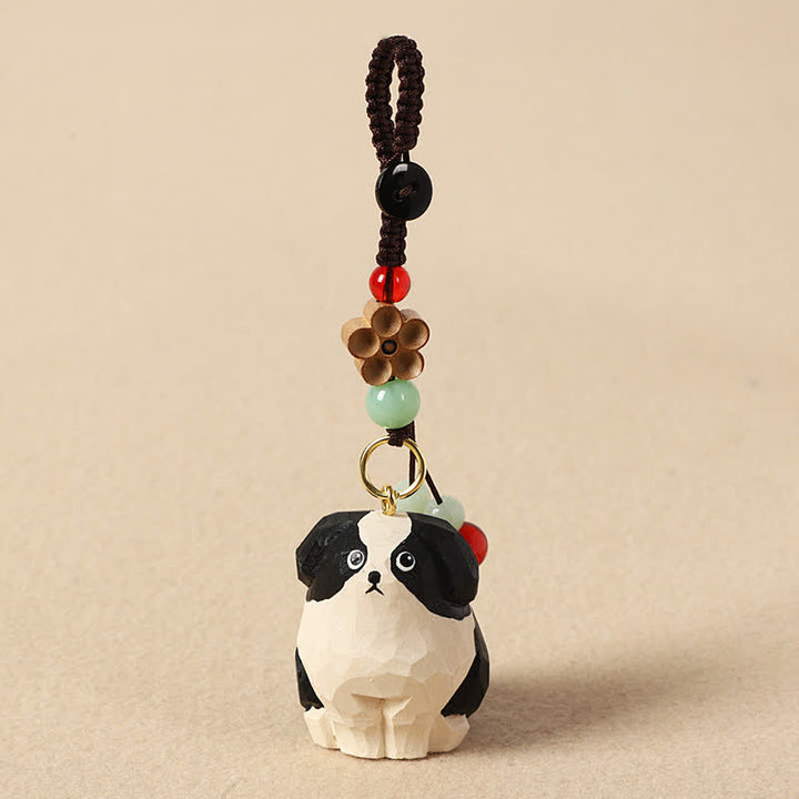 Buddha Stones Porte-clés en bois sculpté représentant un chien, symbole de sagesse Om Mani Padme Hum - Chien noir et blanc - image 0