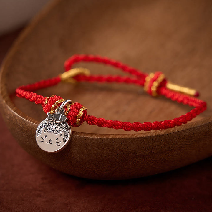 Buddha Stones Bracelet tressé rouge et noir en argent sterling 925 avec pendentif rond représentant un chaton mangeant du poisson, symbole de prospérité. - image 1