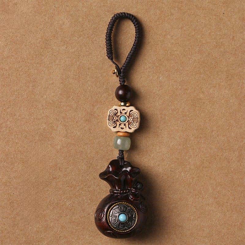 Buddha Stones Porte-clés Sérénité en bois de santal rouge et vert, symbole de bénédiction Om Mani Padme Hum, avec pièces de monnaie chinoises. - Porte-clés en bois de santal rouge - image 0