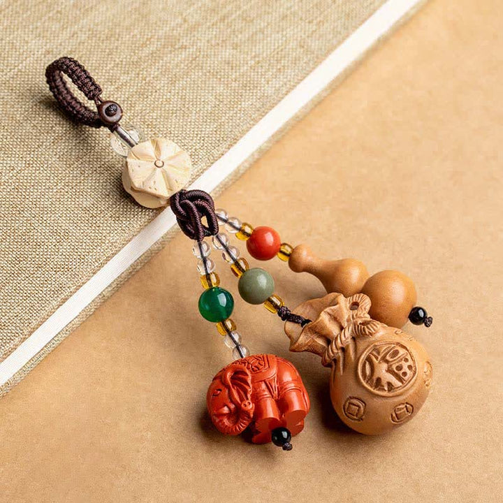 Buddha Stones Porte-clés porte-monnaie en bois de pêcher, personnage Fu, sac à argent, porte-clés éléphant en cinabre et calebasse de lotus - Bois de pêcher (Protection ♥ Purification) - image 0