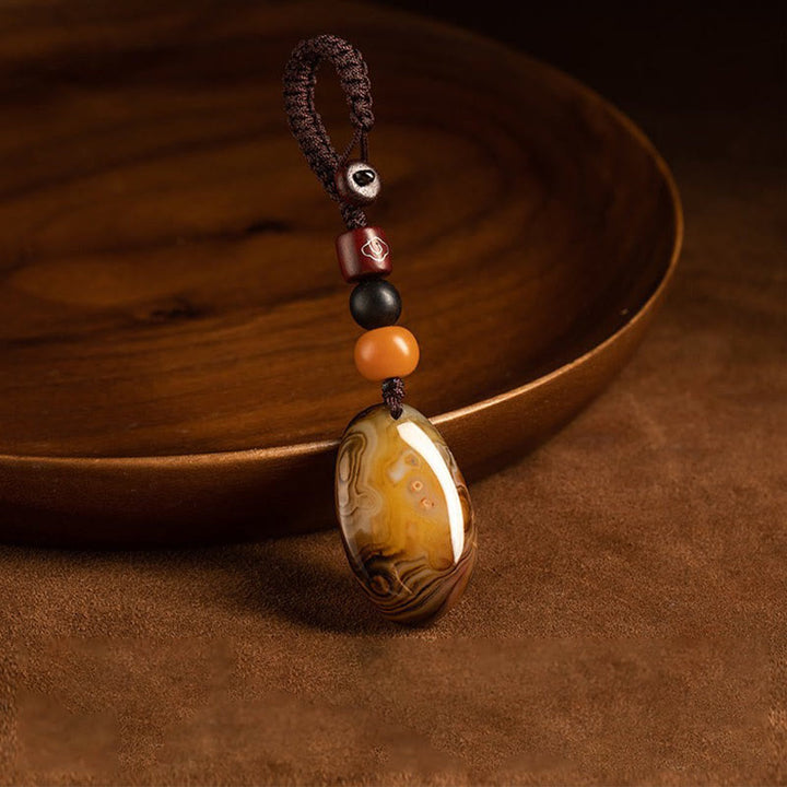 Porte-clés positif en pierre de sardonyx aléatoire Buddha Stones