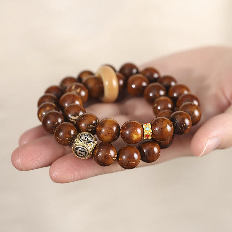 Bracelet double tour en Buddha Stones tibétaines naturelles violettes et dorées avec graines de Bodhi et de richesse