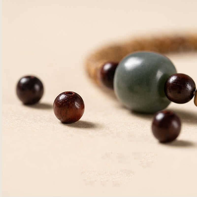 Bracelet de sagesse en bois de santal rouge à petites feuilles et Buddha Stones