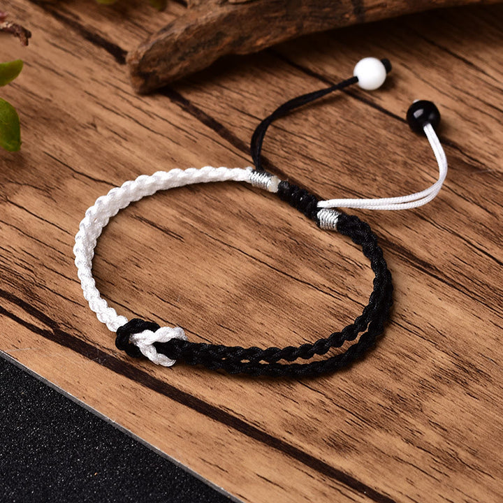 Bracelet de guérison tressé en corde noire et blanche fait main avec Buddha Stones