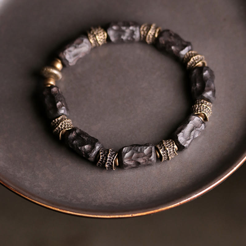 Bracelet tibétain en bois d'ébène et cuivre avec Buddha Stones pour la paix et le calme