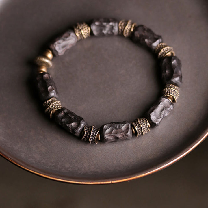 Bracelet tibétain en bois d'ébène et cuivre avec Buddha Stones pour la paix et le calme