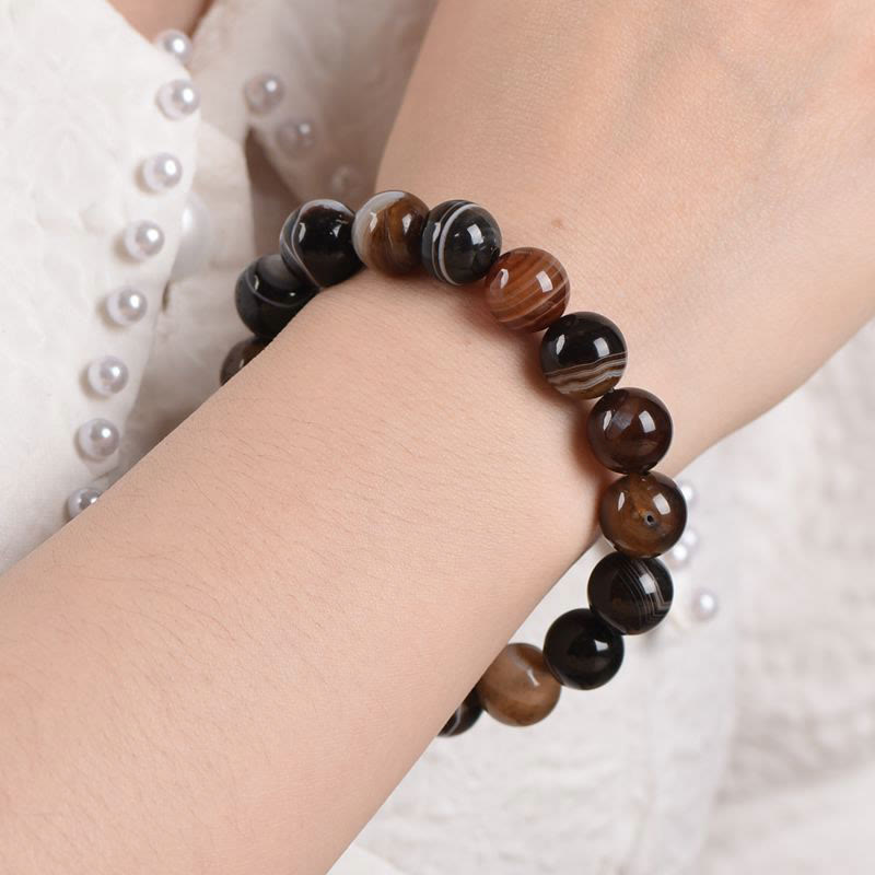 Bracelet de bonheur positif tibétain en sardonyx Buddha Stones
