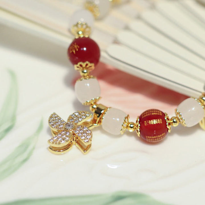 Bracelet de bénédiction avec breloque en forme de moulin à vent en Buddha Stones et caractère Fu