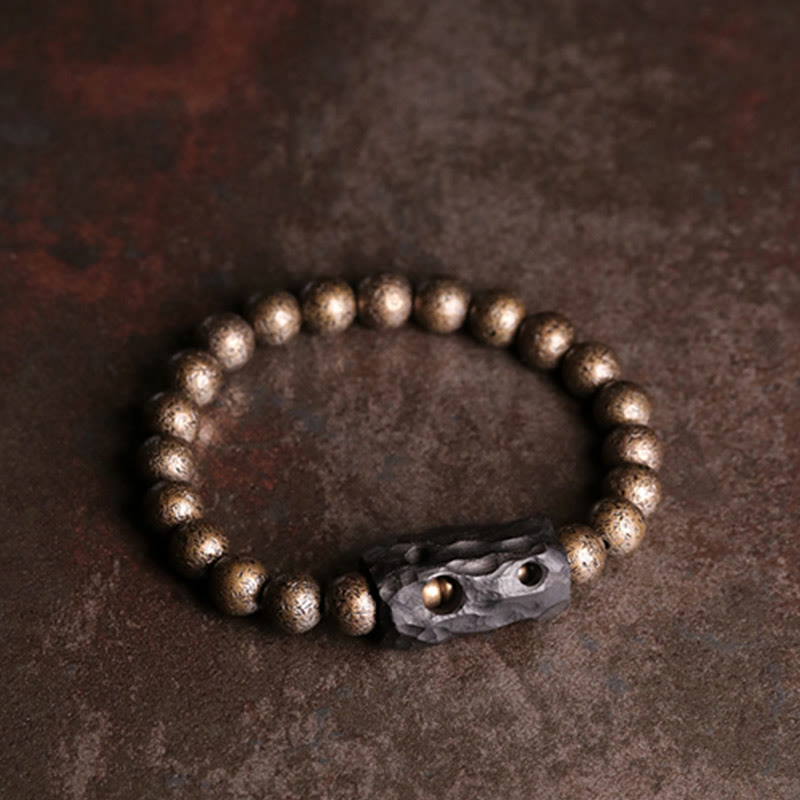 Bracelet de perles en bois d'ébène et cuivre avec Buddha Stones et équilibre
