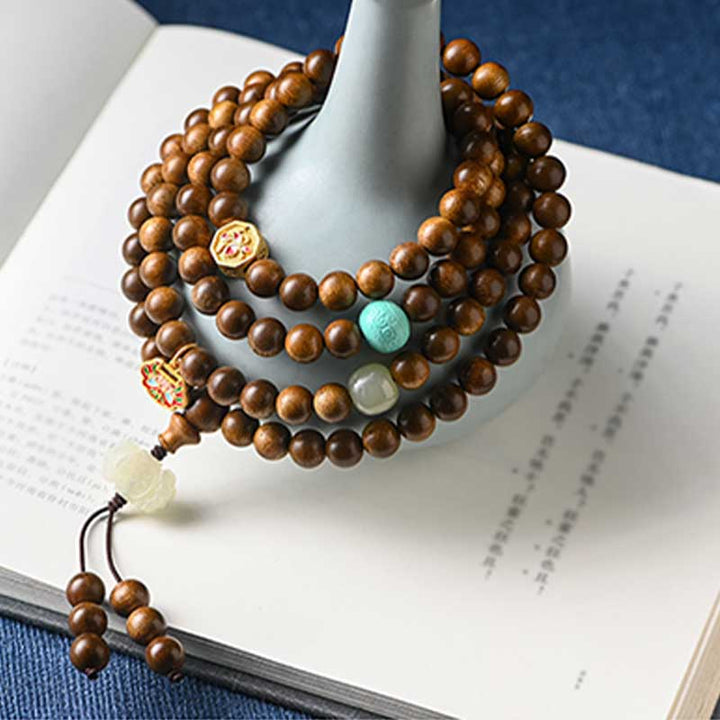 Bracelet Mala tibétain de protection et de calme en bois de rose avec Buddha Stones