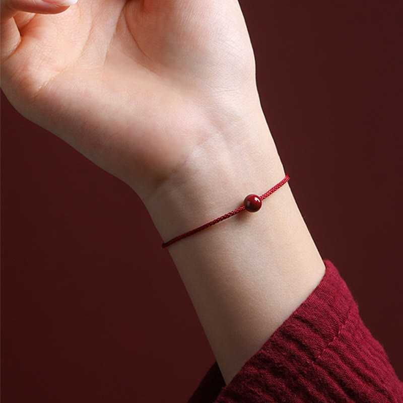 Bracelet en fil rouge avec bénédiction en agate rouge cinabre naturelle de Buddha Stones