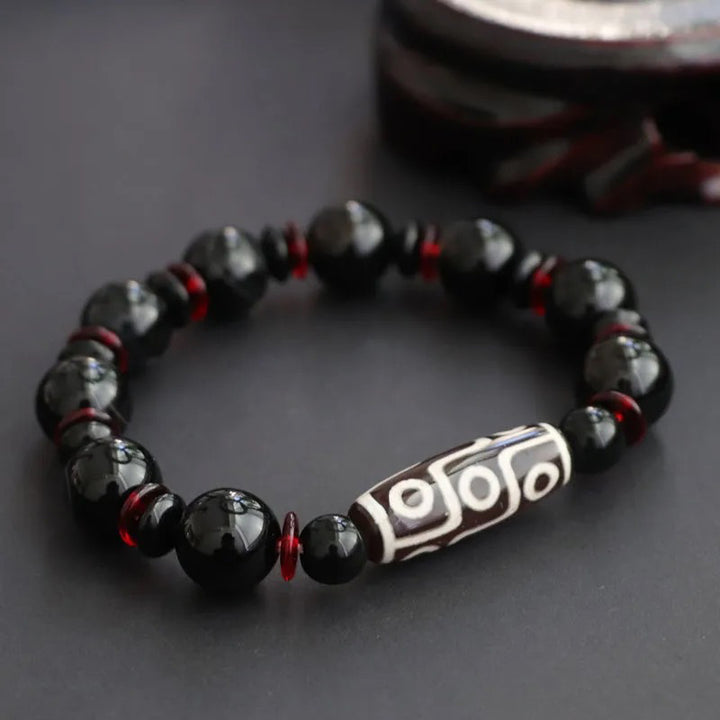 Bracelet de protection de richesse en perles dzi à neuf yeux en onyx noir de Buddha Stones
