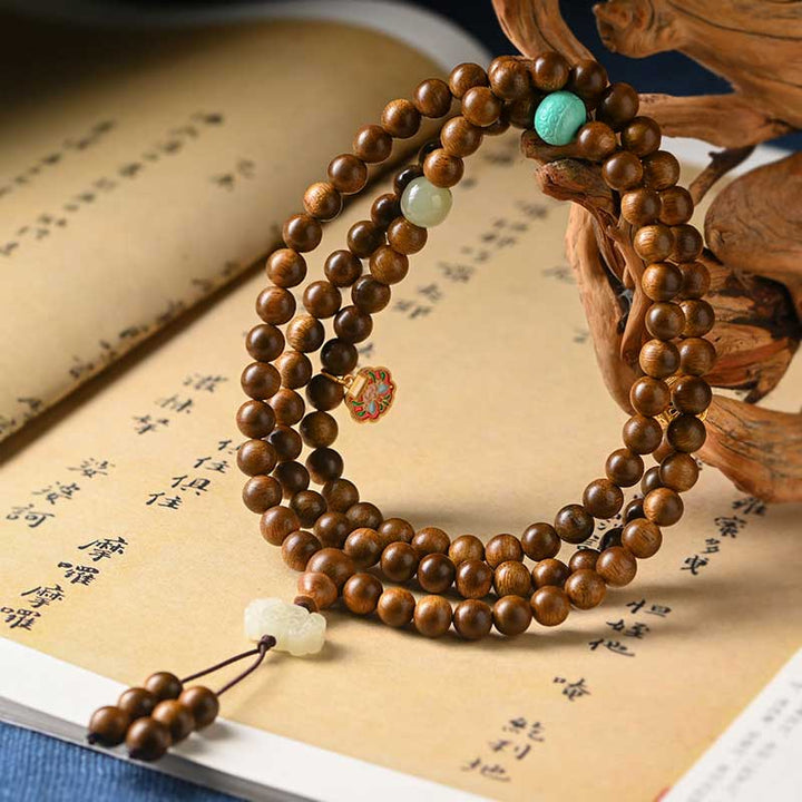 Bracelet Mala tibétain de protection et de calme en bois de rose avec Buddha Stones