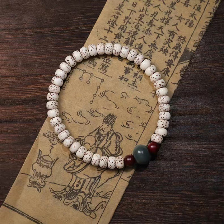 Bracelet de sagesse en bois de santal rouge à petites feuilles et Buddha Stones