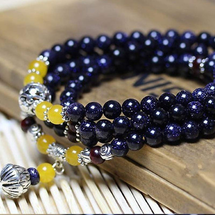 Bracelet Mala en grès bleu avec breloques de richesse et Buddha Stones
