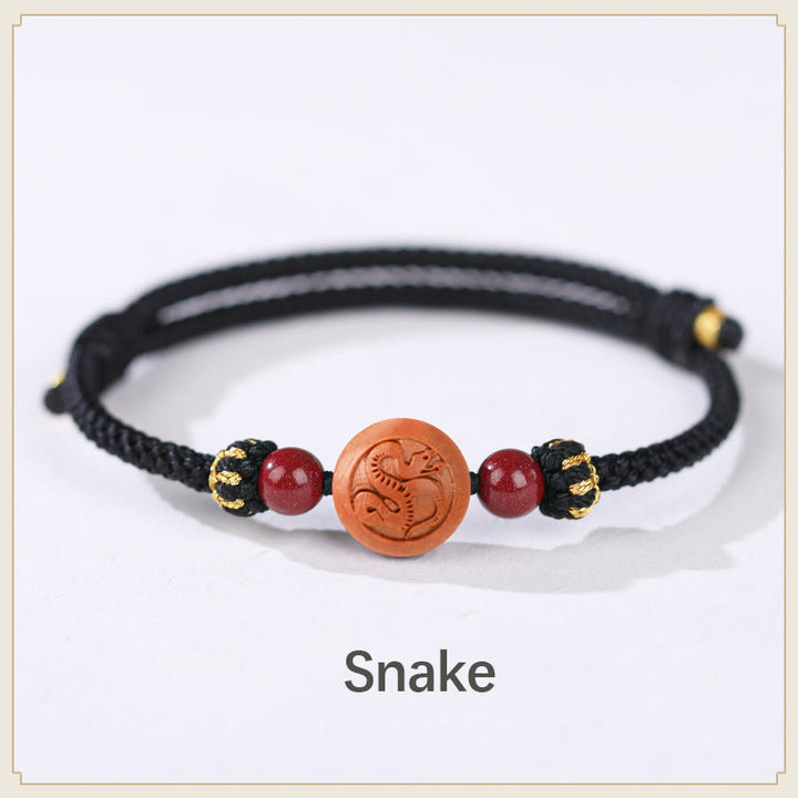 Bracelet de richesse en bois de pêche naturel Buddha Stones et caractère Fu du zodiaque chinois sculpté en cinabre