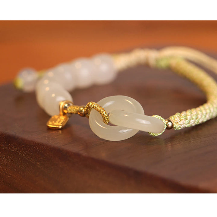 Bracelet tressé en perles de jade Hetian naturelles de Buddha Stones avec boucle de paix double et caractère Fu