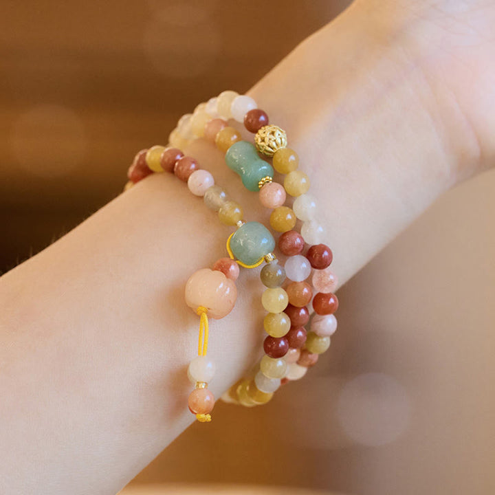 Bracelet triple tour en jade doré et soie naturelle avec breloque citrouille et Buddha Stones