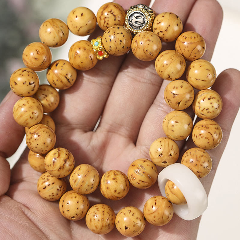 Bracelet double tour en Buddha Stones tibétaines naturelles violettes et dorées avec graines de Bodhi et de richesse