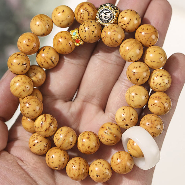 Bracelet double tour en Buddha Stones tibétaines naturelles violettes et dorées avec graines de Bodhi et de richesse