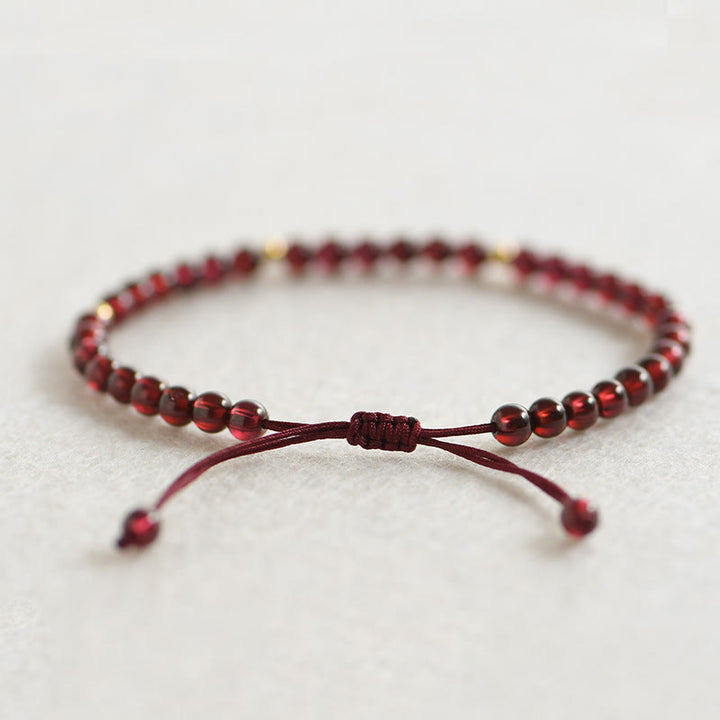 Bracelet de stabilité en perles dorées et grenat naturel avec Buddha Stones - image 1