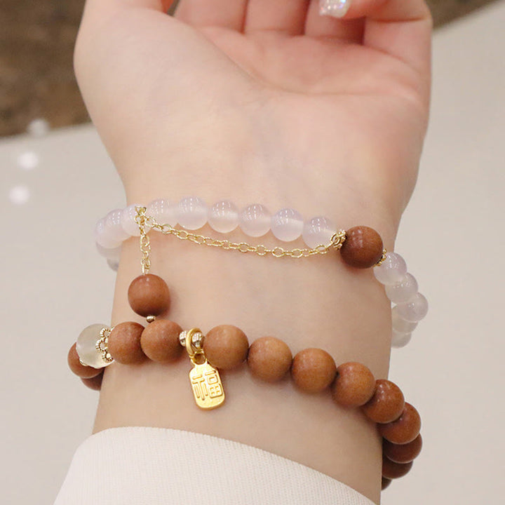 Bracelet de protection à breloques en bois de santal et œil de chat Fu avec Buddha Stones